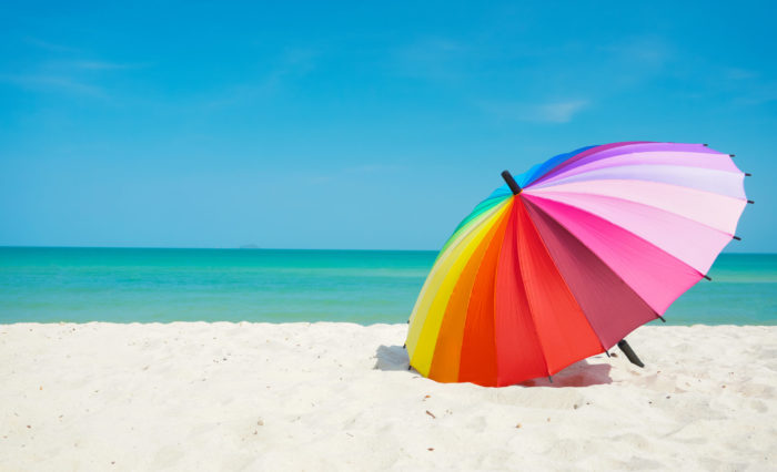 rainbow umbrella on beach sand