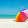 rainbow umbrella on beach sand